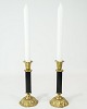 A pair of candlesticks of brass with black metal, in used condition from the 
1920s.
5000m2 showroom.