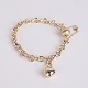 Ole Lynggaard gold bracelet in 14 karat gold with iconic figure-eight links, heart pendant and original clasp